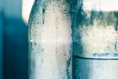 glass bottles of water sweating in the heat